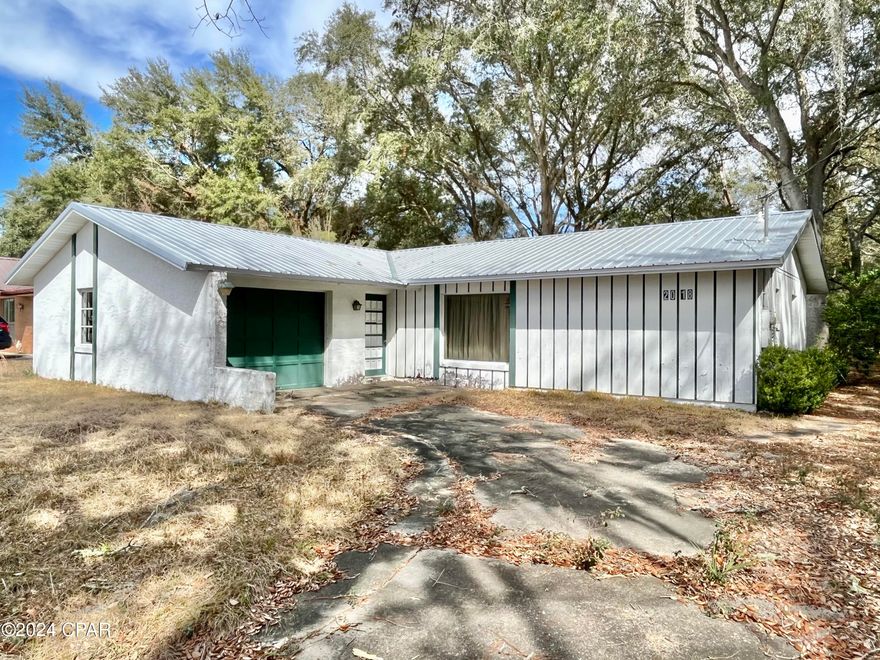 Waterview fixer upper across from Boat Lake! With a new metal roof in 2020, the rest of this home is fairly original and ready for your vision. Situated on a quiet street on a deep lot a short drive from Hwy 77, this home is in need of a lot of work but has plenty of potential! Features include a one-car garage, 2 master bedrooms with en-suites, Florida room at the back of the home, and a large back yard. The home was built in 1978, is on a concrete slab, and has a mainly stucco exterior with some wood accents. Imagine sipping your coffee with a view of beautiful spring-fed Boat Lake.  All of the contents in the home stay and will be the buyer's responsibility after closing. Home is being sold as-is. Cash or rehab loans only.

Sunny Hills is home to the county's first golf course and 26 lakes/ponds, including gorgeous Gap Pond and Boat Lake, a swim park on a spring-fed lake. There are 5 boat landings in the community. Sunny Hills is deed restricted to building only. No HOA fee, but a yearly MSBU assessment of less than $40. Enjoy the slower pace of life this area has to offer and significantly lower taxes.