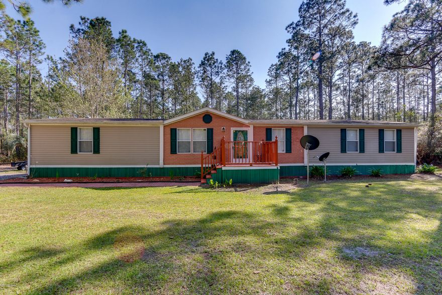 Looking for privacy on acreage close to Callaway & Tyndall Air Force Base? This home has been recently renovated, is super clean and ready for new owners.  This home features a split floorplan, three bedrooms plus study/bonus room, open kitchen, and huge screened porch in the back.  The updates include new carpet, new paint, baseboards, and window treatments.  Extra features include backsplash in the kitchen, new sink & fixtures & bead board in the breakfast area.  With a breakfast area, breakfast bar, and dining area, there is plenty of room for entertaining and prepping for meals.  The master bedroom has an en suite bath with separate garden tub and shower, a double vanity, and walk in closet.  There is a new vanity in hallway bath and fixtures in both baths including two new toilets. The second bedroom has a walk in closet and the third bedroom is also a nice size.  The home is in the preferred X flood zone with no flood insurance required.    There is a well and pump house.  The septic was pumped and inspected in 2015.  Roof comes with a wind mitigation report.  New gutters and downspouts are on the back of the home.  There is a security light on the property ($10 a month) and new asphalt as well.  This home does also have a security system.  Please call your Realtor today to see this home and acreage.  Information is approximate.  If important, buyer must verify.