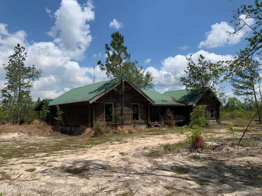 Have you been looking for the perfect rustic retreat?  Look no more.  This beautiful 3BR/2BA log cabin sits on 29 acres and is only 48 minutes to Panama City.  Huge back porch, vaulted ceilings, natural wood, 2 car garage, and beautiful pond.  Home was started back in 2005 and never completed.  It's just waiting for someone to finish it.  Come see today and imagine the possibilities of your new rustic retreat.