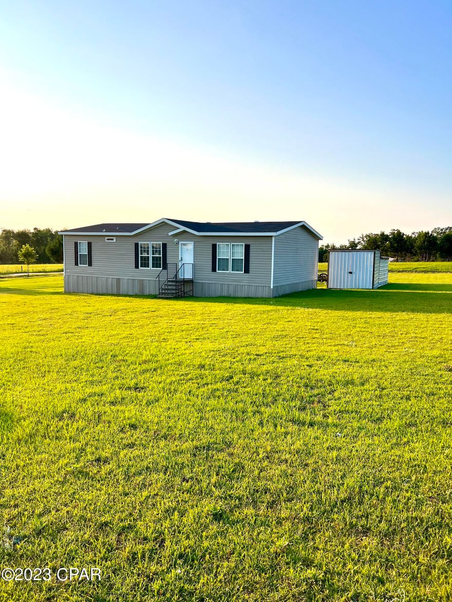 If quiet country living is what you seek then you must tour this 3 bedroom 2 bath well-maintained 2019 double wide mobile home. A short 1/2 mile drive from 231 just south of Cottondale down a paved road leads you to this home on a full 1 acre lot overlooking neighboring pastureland. Convenience is not lost since I-10 is 1.2 miles from the driveway. An added 10x28 outbuilding is powered and can be used for storage or a workshop. This place is turn-key move-in ready and won't last long. Lock it in before it's too late.