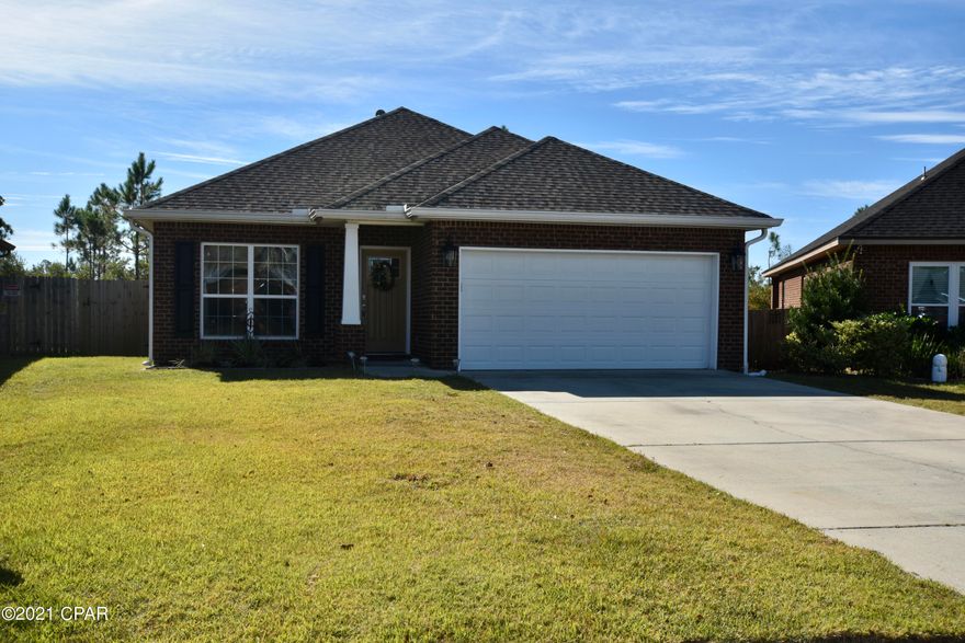 Welcome home to Plantation Park! This beautiful well-kept home is located only minutes to restaurants, shopping, and some of the best schools in Bay County. With over 1725 sq ft, this 3 BR 2 BA is ready for your family. As you enter the home, you will notice the open tiled foyer leading you into the spacious kitchen. The kitchen is sure to be any Chef's favorite with an abundance of cabinets, granite island, as well as a pantry. The kitchen blends seamlessly with the dining area, and overlooks the living room. This home has it all with a nice flowing open floor plan and generous sized entertainment space.  It is move-in ready complete with all appliances including refrigerator, washer, and dryer! Flexibility is the key with the office space; use it as a formal dining area, gym, playroom, or game room! Home features include crown molding and tray ceilings.  All bedrooms are large and spacious. Upgraded flooring: tile flooring in kitchen, baths, and laundry room, while office, living room, and dining areas boast luxery vinyl plank. The backyard is completely surrounded by 6' privacy fence with peaceful wooded views; fence provides safety and security for your children or pets.