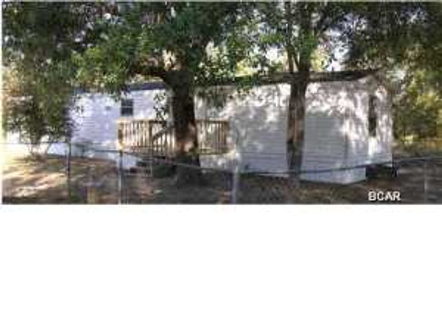 This 2 bedroom 2 bath single wide mobile home is located in the quiet Green Acres Mobile Home Community, on a nicely sized, fully chain length fenced in yard with plenty of shade. This home features a eat-in kitchen that is equipped with refrigerator/freezer, stove/oven, dishwasher as well as plenty of cabinet & counter space. The living room is fully carpeted and the small wall separating each side of the room from the kitchen/dining area has built in shelving. The master bath is directly open to the master bedroom and features a large round garden tub, separate his & her vanities, separate shower & a linen closet space. Central heat and air, and front porch. Water, sewage, washer & dryer included. Come and experience quiet country living. Pets are negotiable with a non-refundable