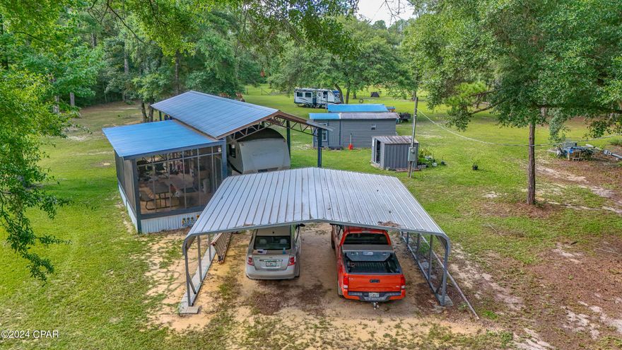 This woodland retreat is nestled between Choctawhatchee and East Rivers and accessible to Pine Log State Forest - without getting on the Hwy.  Nearby public boat ramps afford fishing opportunities and pleasure boat rides. The property is enclosed with a fence (with the exception of a portion across Strickland Rd and a small portion beyond the back fence)   A pole barn with a screened in deck, an insulated bunk house, workshop and lean-to provide several retreat options . . . or a beautiful place to build your dream home.   Public boat ramps are nearby  - as is a proposed Fl Veterans Retreat.   All of this and less than 30  minutes to the white sands of Panama City Beach, ECP airport, Margaritaville or Freeport.  A campers (2007) and lawn mower will convey with sale. The camper is currently parked on the property with full hook up.  There are 2 power poles, 2 wells and 3 septic tanks on the 7.5 acre peaceful paradise.