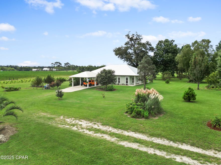 Custom-designed and built Country Estate on 26 acres. This newer home built in 2020, features 2000 sq ft of living space (2920 sq ft under roof), with expansive porches and a detached 2-car carport. There is a sitting platform (ready for a hot tub or fire pit), with electric and water, that is beautifully landscaped to enjoy year-round serenity.  

The home is built to the new hurricane standards with 2x6, 10 ft. walls, 6 ft windows throughout with transoms, low-e tempered glass, Hardi board siding, metal wind-resistant hip roof, and energy-efficient spray foam insulation. Other interior features are 8 ft interior doors, luxury vinyl plank flooring, and a spacious open floor plan. The current Den could easily be converted to a third bedroom. 

The fully landscaped yard has an in-ground irrigation system in the front yard and behind the house. The porches have new, concrete skid-resistant custom color paint flake coating epoxy finishes applied by Deese Elite Custom within the last 6 months.  

There is a garden location that has well established Navajo thornless blackberries and peach trees. There are water lines running to numerous locations at the barn/shop and into the pasture area. 

Conveniently situated to the home is an expansive red steel building with a 400 sq ft. apartment or office and a 20x30 enclosed shop with double roll-up pass-through doors and concrete flooring. The office has a full kitchen, bathroom with shower, a fold down queen size murphy bed with side cabinet storage, and an inviting covered front porch to enjoy the full view sunsets. 

The property's premium location is just minutes (via paved road access) to Marianna Florida, or about 25 minutes to Dothan, Alabama, or about an hour away to Panama City. 

The county estate is suitable for horses and other livestock. The land is zoned one home per acre and has no deed restrictions. With approx. 1240 Highway 71 road frontage, and a county-approved named road, Palamino Lane. This property is easily subdivided if desired in the future.