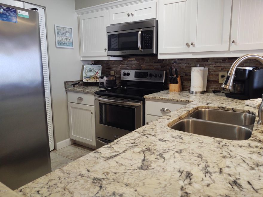 Location Location Location -sought after building.  Beautifully remodeled 2 Bedroom -2 Bath condo at the Dunes of Panama with breathtaking gulf views.  Gorgeous furnishings throughout this condo. Stainless steal appliances with beautiful  granite counter tops.  Gulf views and patio entrance from the living room and the master bedroom.  Dunes of Panama offers 3 pools, tennis court, basketball, shuffleboard, fitness room, outdoor bbq, deli, souvenir shop, poolside bar, beach rental service on site as well.  Resort style living.  Rentals are in high demand at Dunes of Panama.  This top notch condo will not last long.  Call us today for a showing before it is gone.  We are onsite.