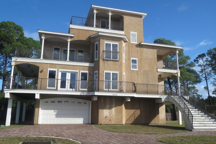 SITUATED IN A GATED COMMUNITY WITH GREAT VIEWS OF THE GULF, THIS FOUR-STORY HOME FEATURES A FULL GARAGE AND STORAGE AREA ON THE GROUND FLOOR. THE SECOND LEVEL OPENS TO A LARGE GREAT ROOM WITH HARDWOOD FLOORS IN THE DINING ROOM AND KITCHEN, AS WELL.  THE KITCHEN BOASTS A BREAKFAST BAR, GRANITE COUNTERS, STAINLESS STEEL APPLIANCES AND CUSTOM CABINETRY.  THIS LEVEL ALSO FEATURES A HALF BATH, AS WELL AS A BEDROOM AND FULL BATH. THE THIRD LEVEL HAS THE LARGE MASTER BEDROOM SUITE WITH A SPACIOUS MASTER BATH AND WALK-IN CLOSET.  AN ADDITIONAL BEDROOM AND FULL BATH ARE ALSO ON THIS LEVEL. THE FOURTH LEVEL WITH WET BAR COULD BE AN ADDITIONAL BEDROOM WITH ITS HALF BATH OR THE PERFECT OFFICE.  THIS LEVEL OFFERS PANORAMIC VIEWS OF THE GULF AND THE SMALL MARINA WITH A SLIP AVAILABLE TO THE NEW OWNER!