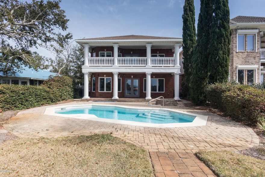 'CURRENTLY UNDER CONTRACT, SELLER ACCEPTING BACKUP OFFERS' Luxurious Custom Home with Captivating Views of Grand Lagoon. Welcome to this gorgeous waterfront home on the desired North Lagoon Drive.  This large custom built, 1 owner, solid brick home features a swimming pool, 4 or 5 bedrooms, 3 full baths, two half baths, an attached office, two laundry rooms, two back porches, an oversized garage, and lots of storage space. Relax on one of the two back porches, in the pool, or on the dock and enjoy viewing wildlife .Enjoy over 4,000 square feet of heated and cooled space. The large angled garage is an additional 1,005 square feet, home has a total of 5,738 square feet under roof. An office with a kitchenette, waiting room, and additional handicapped-accessible half bath is attached. Use this space for an office, game room, play room, gym, or in-law suite. 
The 10 foot ceilings and large windows in the downstairs give the home an open, airy feeling. The living area and stair flooring is Robbins Engineered Oak Wood Floor in 3", 5", 7" widths. Flooring may be refinished to desired color.
Cooking and sharing meals in this large open kitchen. There's lots of cabinet space and a pantry. The bar has room for 6 people and is right next to the dining area which seats 6-8 comfortably. Countertops are Blue Pearl granite. Stainless steel deep sinks with garbage disposal, dishwasher, and oven. Glass cooktop. Kitchen flooring is oversized 18" travertine-look porcelain tile.
In addition to the spacious kitchen and open living/dining area, the downstairs has a laundry room with cabinetry for art projects or storage, a powder room, and a separate room that is just right for an office, workout room, music room, or play room. There's also a large bedroom with a full bath and closet downstairs. The bathroom has a large shower that is handicapped accessible should you need to care for elderly parents or other loved ones with disabilities.
Owners spent $35 K in upfront cost on this desirable geothermal system.Saves 30-60% off of energy bills,
 11,000 Gallon Pool is fiberglass with an acrylic finish. It is smooth to the touch and doesn't scrape your toes! An upgraded glass tile border was installed in 2017 and the Kooldeck was repainted at that time.. Just pull your boat up to this amazing home.
Location, Location, Location
Located on Grand Lagoon on East end of PCB about ½ mile from Captain Anderson's
Walking distance to restaurants, grocery stores, salons, and marinas
1 mile from beach
3 miles from St. Andrews State Park
Sidewalks and bike paths for miles
In unincorpoated Bay County-No HOA fees!
Excellent schools-Patronis, Surfside, Arnold
Convenient deep water access to Gulf 
4 miles from new $72 million sports park 
Fresh seafood markets and marinas close-by
This is a must see, all dimensions are approx.