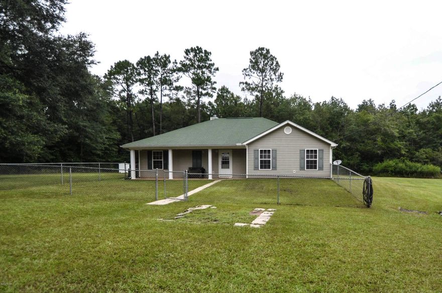 W@W Beautiful home on 20 ac with Holmes Creek frontage. This property is fenced and cross fenced for livestock, horses, whatever you want. Lots of the land is cleared. Great fishing in the creek, great backyard for bbqing, or swimming - or build a deck and entertain 40 of your best friends for dinner! You have a 24x24 carport, 24x16 workshop and a 24x20 pole Barn. You have a pad for an RV already hooked to water and electricity. The AC is brand new. You have a 12x12 block patio for watching the sunset. Just 10 minutes to the tallest waterfalls in Fl, the Marianna Caverns and the Northwest Wolf Preserve. You are close to the worlds most beautiful beaches and not far from the international airport. All sizes are approximate, please measure if important.