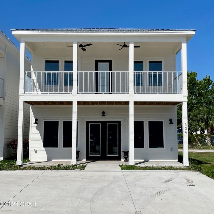 This unique commercial/residential property offers the perfect blend of convenience and comfort. Imagine living just steps from the shops and restaurants of downtown Port St Joe and the marina while running your business from the comfort of your home! The expansive 1,000 sq. ft. commercial space on the first floor provides a flexible canvas for your business needs. Design your dream workspace or lease it out for additional income. Upstairs, unwind in your private 1,500 sq. ft. sanctuary. The modern open floor plan features a large kitchen and living area, ideal for entertaining or relaxing. Three bedrooms and two baths provide ample space for you and your family. Short-term rentals are allowed! The living area boasts modern finishes throughout, including granite countertops, LVP flooring, and storm windows for year-round comfort. Brand new appliances are already installed for your move-in convenience. Take a refreshing dip in the complex's brand new, shared saltwater gunite pool - a perfect way to unwind after a long day.