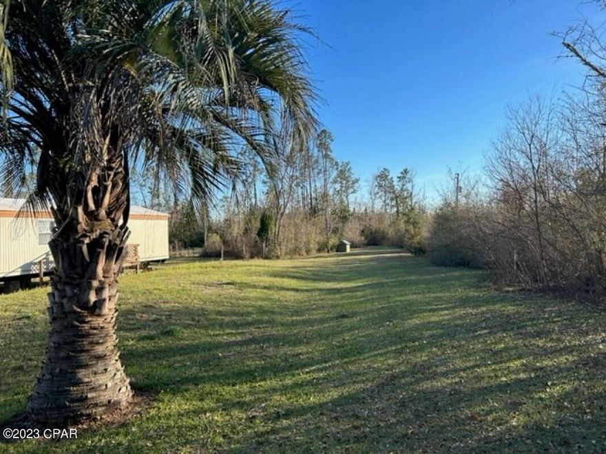Beautiful building site with 7 acres on Bear Creek with many amenities. Currently has an older mobile home. Fenced, has a pond, 2 septic systems, 3 power poles, 3 wells, new storage shed with deck, 3 RV hookups (30 amp), 24x36 pole barn by creek, creek house with power, water, septic, livestock area, 2 entrance gates. Paved road close to hwy 231.