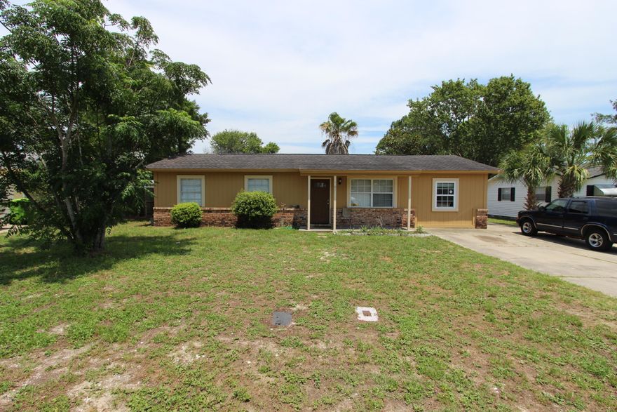 Don't let the looks fool you. This house is much bigger than you think. Interior includes 4 bedrooms with split bedroom floor plan. Sunken master bedroom with recessed lighting, trey ceilings, master bath includes large jacuzzi tub. Enjoy large family room with marble wet bar, hardwood floors. Private enclosed gazebo area (lanai), detached oversized 2 car garage with electricity and work area. Fenced backyard. All this within 4/10 mile to the water. Make an offer today!