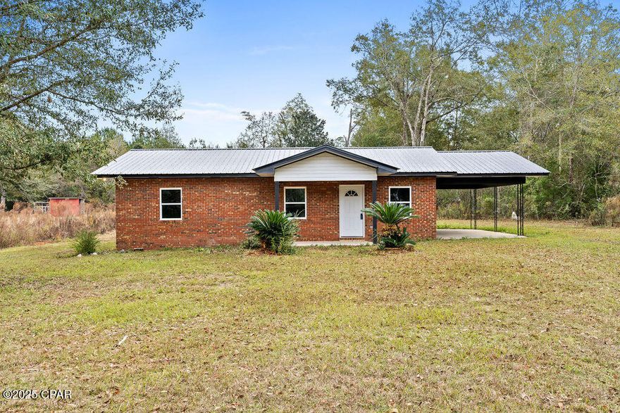 Completely renovated and move-in ready! This charming 3-bedroom, 1-bath brick home sits on a full acre outside the city limits of Chipley, offering peaceful country living while still being on a beautifully maintained paved road. Enjoy a quiet residential setting perfect for evening walks, bike rides, and outdoor activities in a community with minimal pass-through traffic.
Most everything is new including: NEW WELL, black metal roof, HVAC system, hot water heater, windows & exterior doors, interior doors, paint throughout, vinyl plank flooring, light fixtures, kitchen cabinets, sink, island, appliances, bathroom vanity, sink/fixtures, toilet & shower. The home sits on a concrete slab, includes a single-car carport, and features a huge backyard with space for a pool, pole barn, garden, or anything else you can imagine. The multi-colored, dimensional brick gives this home unique curb appeal and timeless character.  A beautifully updated home with land like this doesn't come around often; schedule your showing today!
