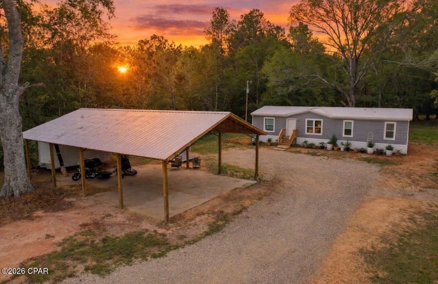 BETTER THAN NEW! Welcome to your private country retreat in Graceville! This 2025 Timberline home sits on over 5 beautiful acres and offers the perfect blend of modern comfort, efficiency, and peaceful rural living.

With 4 bedrooms and 2 bathrooms, this thoughtfully designed home features a spacious split floor plan, high-end vinyl flooring throughout, and stylish white cabinetry with soft-close features. Built with energy efficiency in mind, the home includes 2x4 construction, a durable metal roof, ceiling-mounted HVAC vents for improved airflow, and LED lighting throughout.

Step outside and enjoy everything this property has to offer. The home is ideally positioned near the center of the acreage, with a fenced front yard perfect for pets or children, a hobby garden, and a combination potting shed and chicken coop ready for your homestead setup. A 30x40 pole barn on a concrete slab provides excellent storage for equipment, vehicles, or recreational use, along with an additional 8x12 storage shed.

The property is fully equipped with a brand new well (with warranty) and a new septic system. There is also an RV hookup with its own power pole, offering flexibility for guests or additional use.

Enjoy the quiet surroundings with minimal traffic, as the home is located near the end of a paved road. The property is bordered by pastureland and wooded areas, offering privacy, scenic views, and frequent wildlife sightings including deer. A trail runs through the back portion of the property, leading to a small natural pond area, adding to the charm and usability of the land.

Conveniently located approximately one mile from Highway 77 and centrally positioned between Graceville and Chipley, you are just a short drive from grocery stores, restaurants, medical facilities, and everyday conveniences.

This move-in ready property offers space, functionality, and a peaceful lifestyle all in one. Schedule your private showing today!
Bring a zip line, a treehouse, all the animals, your dreams and buy your farm!