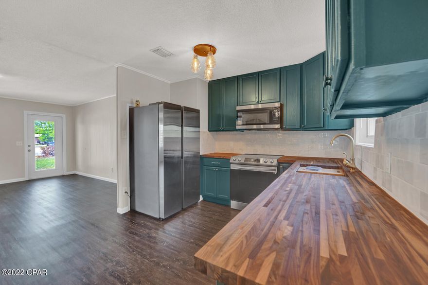 Beautifully remodeled home in Panama City, on a pond. This well-appointed, 1434 sqft, 3 bedrooms, 1.5 bath home is situated on over a quarter of an acre. New AC in 2021. City water and sewer. This brick home features a new roof, a new A/C, new luxury vinyl plank flooring, new paint, and so much more! The kitchen has new cabinets, new butcher block countertops, new stainless appliance, and tile backsplash. The open concept living area is adorned with wood trim, brick fireplace, and plenty of room for all your furniture! The master bedroom has a large walk-in closet and new LVP flooring. The master bathroom features tile floors, new vanity with tile splash strip, and a new tiled shower/tub combo. The half bath features a new single vanity and tile flooring. There is a shed out back that has a good foundation for a workshop or storage. This home has been completely remodeled and is waiting on its new owner! All measurements are Approx. Please verify if important!