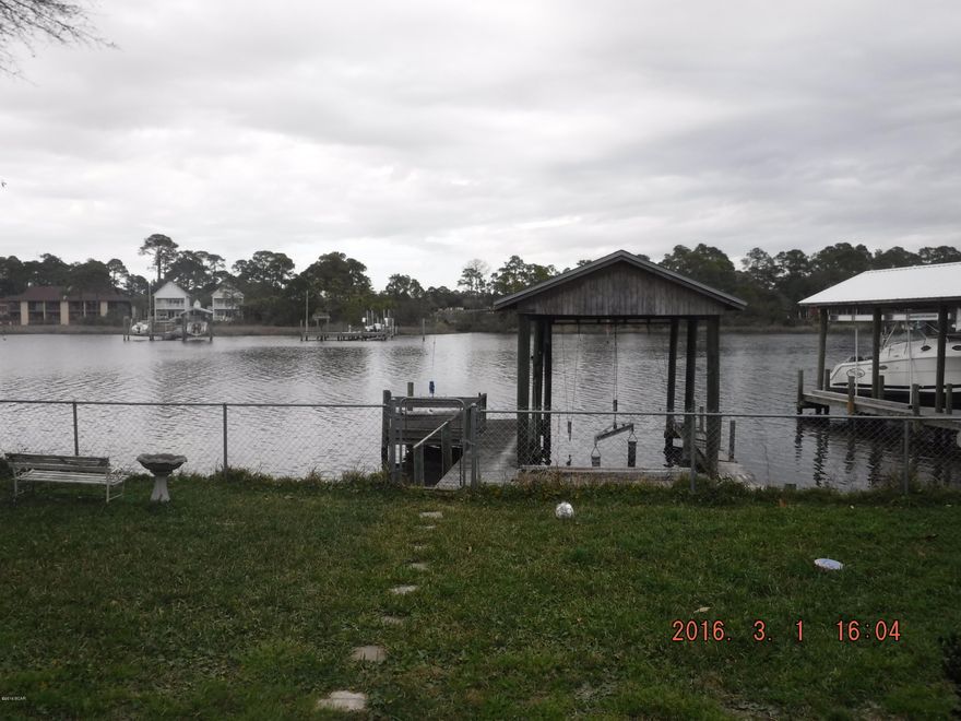 Here's your chance to live the dream!  This lagoon front brick home has a boat lift and dock in the backyard.  Drop the boat and go fishing or enjoy the beach by boat just by walking out your back door. AND it is just a half mile walk to the beach so you get the best of both worlds in this envious location.  The home has a wood burning fireplace in the living room.  The master bedroom has French doors that open to a sun room with a hot tub overlooking the water.  Schedule a tour to see if it feels like your new home.  Motivated sellers!