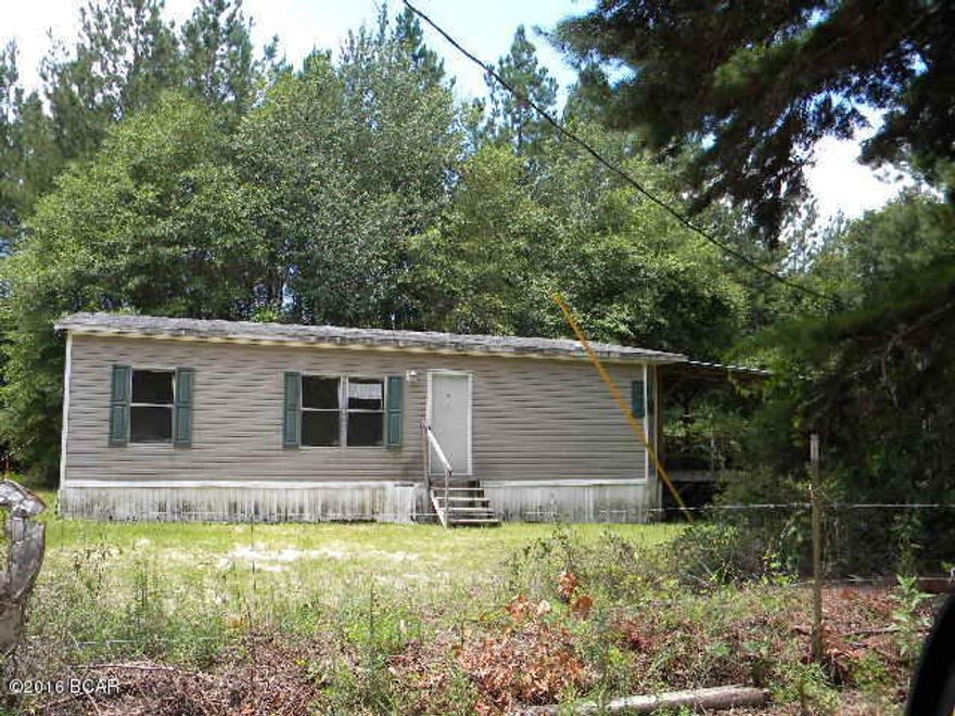 Located just off of a paved road this newer 2 br, 2 ba, mobile home on 1 acre with a large covered porch is waiting for a new owner.  This charming home has a cute kitchen with lots of cabinets, interior is roomy and bathrooms are oversized.  Home is FHA insurable with Escrow repair.  Don't miss seeing this cutie.