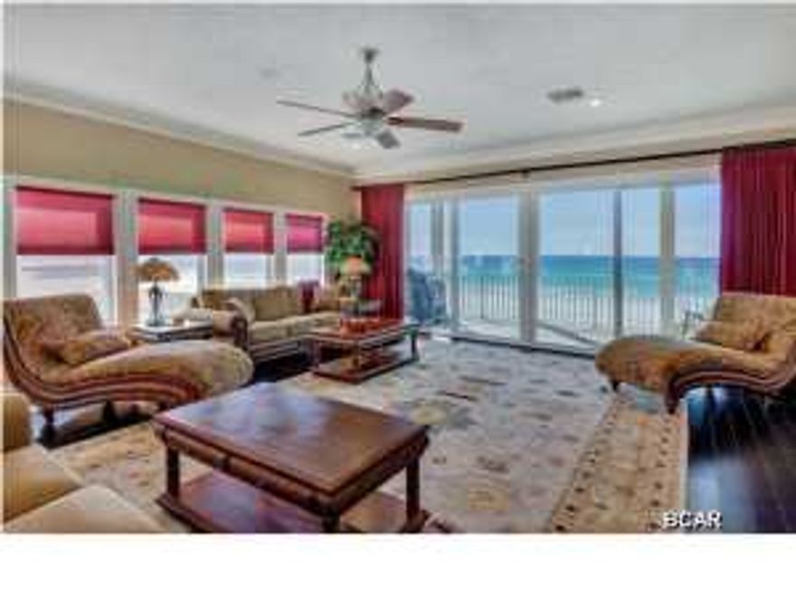 This town home is absolutely stunning inside and the views are even more incredible. Offering 2,230 square feet on two levels with 30 feet of Gulf frontage, this property is truly spectacular. Elevated high on pilings with parking underneath, the views from the living areas are the best around. And the town home only has one common wall so the side offers even more expansive views down the beach. High ceilings, gas fireplace, built-in shelving, custom kitchen w/gas stove, granite counter tops, exquisite glass tile, ebonized hardwood floors, wine cooler, and look how beautifully furnished! The covered decks across the back are huge! It is very difficult to find a property this beautiful and in this price range on the beach. Put this one at the top of your list because you don't want