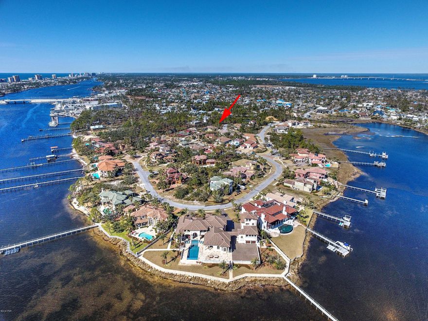 CURRENTLY UNDER CONTRACT, SELLER ACCEPTING BACKUP OFFERS''.Build your dream home in the wonderful community of Finisterre located in Panama City Beach! Finisterre is a gated, waterfront community that is located on Grand Lagoon with tennis courts, a park for kids and a community dock where you can purchase your own private boat slip. Finisterre is walking distance to great restaurants and marinas and is only a short drive to the world's most beautiful beaches. This interior lot is located near the end of Bella Casa Place and is very private. The lot next door is also for sale at this time if you are looking for 2 adjacent lots so you can build a larger home in Panama City Beach. Finisterre has been removed from the CBRA zone and is now eligible for subsidized flood insurance! It is a great