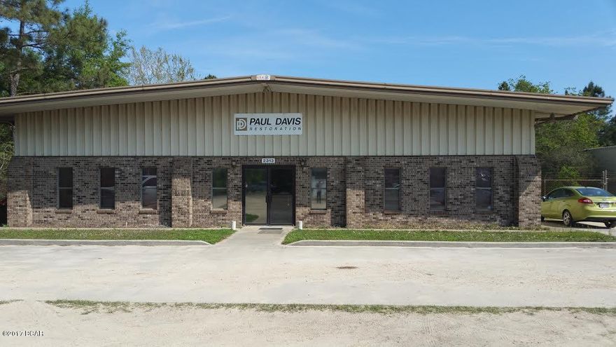 . 6,540 SF freestanding metal building with approximately 4,000 s.f of multiple office, conference, and break room with CAT 5 wiring throughout all offices. 11 x 5 concrete vault/safe room. Total of 8.5 tons HVAC  2400 SF warehouse includes 3- 10x10 large roll up doors, 14 ft. eaves, phase 3 electric on site. On city water and sewer, well on site.  Fenced in 6-foot barbwire fence.  In addition, there is a frame structure on a 14x80 slab with multiple garage bays ideal for vehicle storage or maintenance. The buildings are situated on a 147 x 275 lot (.832 acres) Plenty of parking and brick facade on front of building.  IND-2(Bay) zoning which is great for light manufacturing and commercial use.