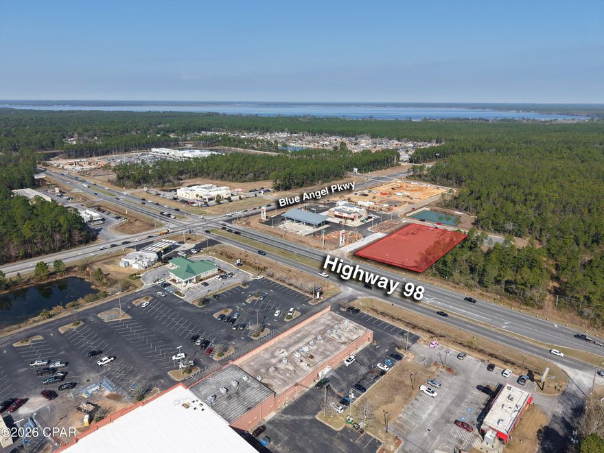 +/-1.15 Acres Ground lease opportunity located at Highway 98 and Blue Angel Parkway, one of Pensacola's fastest growing and most active commercial intersections. The site offers approximately +/-167 feet of frontage along Highway 98, capturing strong east-west beach traffic while benefiting from north-south commuter flow along Blue Angel Parkway, the primary corridor serving NAS Pensacola, Perdido Key, Gulf Shores, and surrounding residential communities.

The property features a direct curb cut along Highway 98 for immediate site access, along with signalized, lighted access to Blue Angel Parkway, enhancing visibility and traffic flow. The intersection carries a combined daily traffic count of approximately 37,300 vehicles, delivering exceptional exposure from both major thoroughfares.

Wawa is currently under construction immediately adjacent to the property, with vertical structure already in place and opening anticipated soon, creating a significant daily traffic generator and co-tenancy driver. The corridor continues to experience rapid retail expansion, including a new Publix-anchored shopping center nearby, ALDI now open, and Whataburger recently announced and under development. More than 10,000 square feet of new retail space has been delivered or is underway within the immediate trade area, reinforcing strong national retailer confidence and sustained consumer demand.

Surrounding residential growth, coupled with the stable employment base of Naval Air Station Pensacola, supports strong daytime and evening traffic patterns. With ongoing corridor improvements and expanding commercial investment, this highly visible corner parcel is ideally positioned for retail, QSR, medical, or build-to-suit users seeking dominant frontage in one of Pensacola's most strategic growth corridors.

Off-corner position with strong visibility at the major intersection of Hwy 98 & Blue Angel Pkwy (Combined AADT: 37,300)
Direct curb cut along Highway 98 with 167 feet of frontage (AADT:19,300)
Signalized lighted access to Blue Angel Parkway - Primary north-south commuter corridor (AADT: 18,000)
Adjacent to new retail construction and recent pad development, including Wawa (under construction), Publix, McDonald's, Whataburger (announced), and ALDI
Primary access corridor to NAS Pensacola and the Perdido Key / Gulf Shores beach markets 
Ideal for Retail, QSR, Medical, or Build-to-Suit