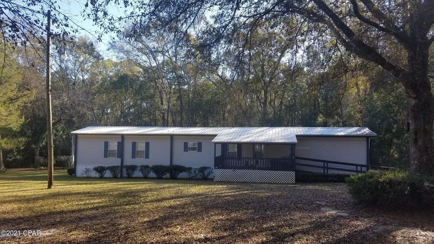 Awesome manufactured home in Bonifay! This 3 bedroom, 2 bath home has an open floor plan with a large open kitchen and dining room. A recent addition to the back of the home includes the 3rd bedroom. The home has a tin roof, large front and back porch, and a nice sized shed with carport. There is also a carport that will house an RV/Camper. This half acre lot is perfect sized and beautifully maintained. City Water and garbage pickup! Great spot with great neighbors. Large oak trees adorn the property along with a tool/lawn equipment shed. All in GREAT condition! Call today to get this PRICED TO SELL home for under 100k!