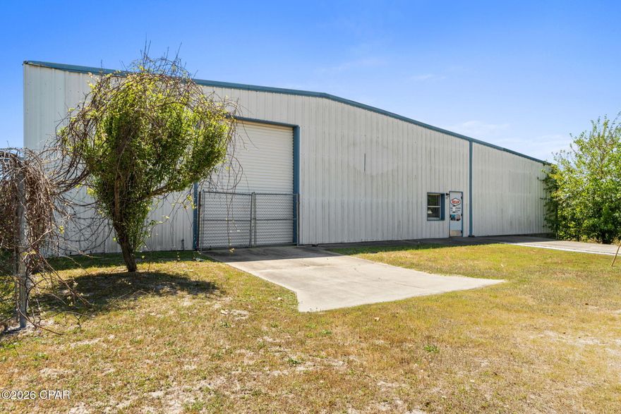 2.35 ACRES | MIXED-USE ZONING | LARGE WAREHOUSE OPPORTUNITY NEAR TYNDALL AFB - Positioned on the east end of Bay County, this offering includes two parcels totaling approximately 2.35 acres of mixed-use property. The fully fenced site features dual ingress and egress points, allowing for smooth traffic flow and operational efficiency.

The property is anchored by a well-constructed 7,600 SF warehouse (see floor plan in documents) equipped with dock-high loading, two 14' roll-up doors, two 10' roll-up doors, drive-in access, and pull-through capability exiting onto N Claire Ave.--ideal for logistics, distribution, or service-based operations.

An expansive yard provides ample laydown and maneuvering space, perfect for equipment, fleet, or contractor use, all within close proximity to Tyndall Air Force Base for added strategic value.

Zoned mixed-use, the property offers a wide range of potential uses--buyers are encouraged to contact Springfield's City Clerk for specific allowable uses and development opportunities.