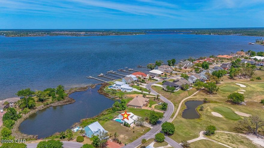 Experience refined coastal living where championship golf meets serene waterfront beauty. Perfectly positioned within the prestigious Panama Country Club--one of the area's most historic and sought-after golf communities--this exceptional 4-bedroom, 3.5-bath residence offers sweeping views of both the Bayou and the Bay as well as a private pool overlooking the water.

Set on a prime waterfront homesite, this property is designed for those who appreciate relaxed luxury living, privacy, and a deep connection to nature. Whether you enjoy kayaking at sunrise, paddleboarding along the calm waters, or simply taking in the peaceful surroundings, this home delivers a true waterfront lifestyle. Spend your days watching dolphins play, fish jump, and a variety of birds and ducks glide across the water--right from your own backyard.

Inside, the home showcases an elegant open-concept design with soaring ceilings and abundant natural light. The primary suite is a private retreat, featuring a walk in closet and private bathroom with an additional walk in closet, double vanities and tile shower. A second main-level suite, complete with kitchenette and private entrance, offers the perfect space for guests or multi-generational living.

The beautifully updated kitchen features an apron-style sink, newer appliances, and a functional layout that flows seamlessly into the main living areas--ideal for entertaining in style.  Sit and enjoy the beautiful water view from the breakfast nook, bar or dining area.

Upstairs, a private bedroom opens to its own balcony overlooking the lush golf course, while a spacious bonus room provides flexibility for a 4th bedroom, media room, office, or additional living space.

Step outside to your personal waterfront oasis, where a sparkling pool and expansive outdoor living areas create the perfect setting to relax and take in breathtaking sunsets over the Bayou.  If you want more land, the lot next door is also for sale!

As part of Panama Country Club, residents have the option to enjoy exclusive amenities including golf, a bayfront pool with cabana bar, and a revitalized clubhouse--further enhancing this elevated lifestyle.

This is a rare opportunity to own a home where luxury, golf, waterfront living, and nature all come together beautifully.