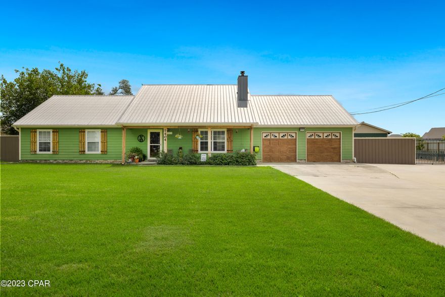 *Country Compound 1.23 acres * Don't miss the great opportunity to own a great custom built home with many many extras... 3 large bedrooms with 2 1/2 bathrooms, half bathroom is close to pool for easy outside use when wet. Beautiful patio with pavers that is fenced off separate from main back yard that is also fenced. There is a great out door kitchen with a bar area that is next to large above ground pool with deck area. A great family hang out area. Beautiful yard with fruit trees and fenced garden area. large work shops ,36x54 and 36x24 carport in back yard,  main garage with house has a large finished attic walk in space with shelving. Great bonus room 360sq ft for playroom or home office with separate door for entry.  House has security system with cameras and remote gate access to back yard. Located close to Lynn Haven with a country feel, boat ramp access to Deer point lake is 1mile and salt water boat ramp 4 miles for boaters. All measurements are approx and need to be verified by buyer.