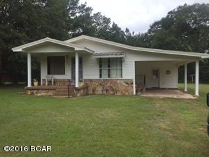 Looking to live in the city limits? This cute 2/1 home place features a new metal roof, new A/C, and master bedroom has two walk in closets. Kitchen overlooks the dining area that follows into a spacious living room.  Home exterior is vinyl and stone, has a 1 car carport and outside, oversized utility with storage. Nice yard with storage building in back. All of this located near the schools, hospital and shopping.