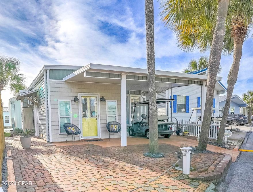 Here's your chance to discover the best of Venture Out! Check out this stunning 2 bedroom, 2 bath charmer. Great living room and large kitchen.  Beautiful wood ceilings throughout and furnished beautifully! New roof in 2018 and HVAC.  You will love the covered patio, nice for relaxing after a long day on the beach! Perfect opportunity for investment or second home.  Venture Out is a golf cart community that has exploded with popularity recently... With 300' on the beautiful pristine beaches of the Gulf of Mexico and 1,000' on the Grand Lagoon. Venture Out has something for everyone.