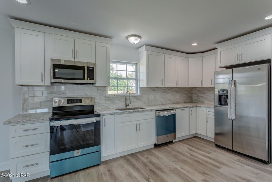 Brilliantly remodeled Brick home with 2021 details but original charm. New Roof, Luxury vinyl plank floors that seemlessly flow throughout the property. New Electrical & HVAC system. Seller added new Insulation, recessed lighting, duct work, interior and exterior paint. Owner splurged on Beautiful light fixtures, high-end backsplash, stainless steel appliances and soft-close cabinets to enhance the kitchen. Large upper and lower cabinetry with granite countertops in both the kitchen and bathrooms. The Low E windows, Stained glassed front door and double French doors that lead to a Huge backyard, will amaze.

Bathroom Showers have tile surround, glass doors, and tiled floors. Over 1/2 acre of cuteness, with a privacy fence.. nestled on a quiet street. The large laundry room has space for a sink, Mud-bench and enough storage for an extra Pantry! Outside has a double carport with a manicured lawn and flower beds. Perfect for a Family or Empty-Nester!