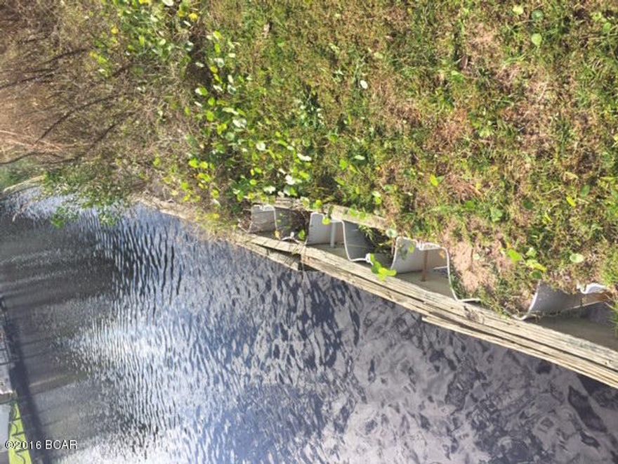 This cleared beach canal front lot is located in the gated neighborhood of Dolphin Bay. There is a sea wall in place. The neighbor has had a 65' foot boat behind their lot so the seller believes you can do the same. The neighborhood boasts a marina (you can use the boat ramp but the slips must be rented) there is also a tennis court and some nature walking trails.Seller has a survey!