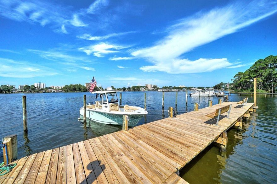 What a view and what a peaceful Grand Lagoon neighborhood! The Seller moved to Texas but hopes his homestead brings as much enjoyment as he experienced in the last 25 years living there. The dock is very nice and boat slips are available. There is covered parking outside your door for one vehicle and an extra space for another. This would be a great second home if you can't live here full time. It is close to at least 5 or 6 fabulous restaurants as well as to a Publix and to a Winn-Dixie grocery store. The ST ANDREWS State Park is close enough for entertainment and your own backyard gives way to beautiful skyline views of the beachfront condos. Imagine watching the fireworks displays from your patio or dock! It doesn't get much better than this, especially for the price!