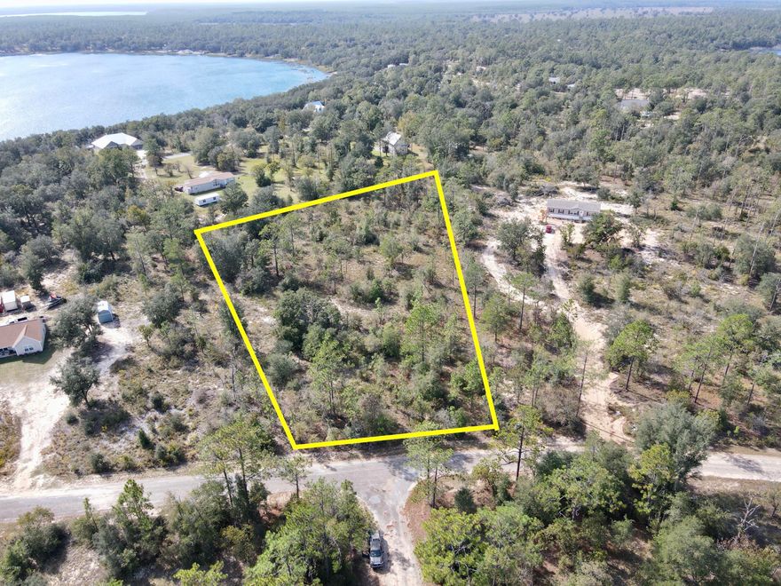 2.58 lightly wooded acres high and dry on Partridge Place (paved road) at Leisure Lakes, only about a block over to the large, beautiful, Lake Denise.  It wouldn't take much to clear out a space for your homestead or weekend retreat! Site built or new mobile homes are allowed. This community offers a swimming pool, security gate guards on weekdays, covered pavilion, playground, boat launch (no gas engines), basketball court, and tennis court.