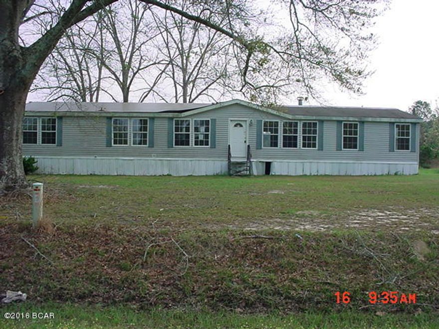 4 bedroom 3 bath doublewide mobile home on 1.5 Acres.  Home needs a lot of work. Roof has leaked. Being sold ''AS IS'' Located on paved road.  Short distance to town.