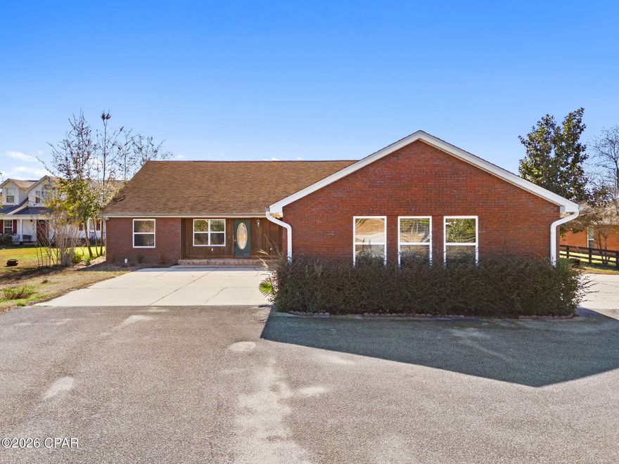 4330 De Len Drive, is an exceptional 1.6-acre waterfront property nestled along the tranquil shores of Deer Point Lake in Panama City. This rare find offers the perfect combination of expansive space, functional design, and breathtaking natural beauty, making it ideal for anyone seeking true Florida waterfront living.

Inside, you'll find 3 bedrooms, 2 bathrooms, and a versatile bonus room that can easily serve as an office, playroom, or guest space. The open-concept floor plan seamlessly connects the living room and kitchen, creating a spacious and inviting atmosphere perfect for everyday living or entertaining family and friends. Large windows fill the home with natural light and showcase sweeping views of the lake from multiple vantage points.

The outdoor spaces are designed to maximize enjoyment of the property's incredible setting. A fenced backyard provides privacy, while the covered patio and fully equipped outdoor kitchen create the perfect venue for lakeside cookouts, sunset dinners, or simply unwinding with the peaceful water as your backdrop. With direct lake access, boating, fishing, and paddleboarding are right at your doorstep.

This property also caters to those who need abundant storage and workspace. A spacious workshop with two covered parking spaces is perfect for tools, hobbies, or equipment, and the four-car garage with rare pull-through access from both sides offers unmatched convenience for vehicles, boats, or trailers.

Situated on a quiet stretch of Deer Point Lake yet just minutes from shopping, dining, and schools, this home provides both privacy and convenience. Whether you're searching for a full-time residence or a private retreat, 4330 De Len Drive delivers a lifestyle where every day feels like a getaway