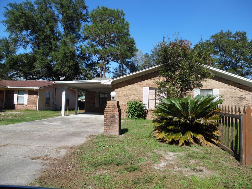 Here's a great opportunity to own a brick home, with a lovely large back yard, covered carport parking and a quiet neighborhood.  This affordable home has a master bedroom with full bath, 2 secondary bedrooms that share a hall bath, a large laundry room and an open-concept floorplan with full visibility of kitchen, dining, living room and sliding glass doors.   There is an outdoor storage room adacent to the large covered patio.  This attached, single family home is super-convenient to Tyndall AFB and schools; and is just 13 minutes from downtown Panama City and local hospitals/doctors.  Best of all, there is no Homeowner's Association or HOA fees.  (All info, dimensions, schools, etc.  is approximate and anything important to buyer should be verified.)