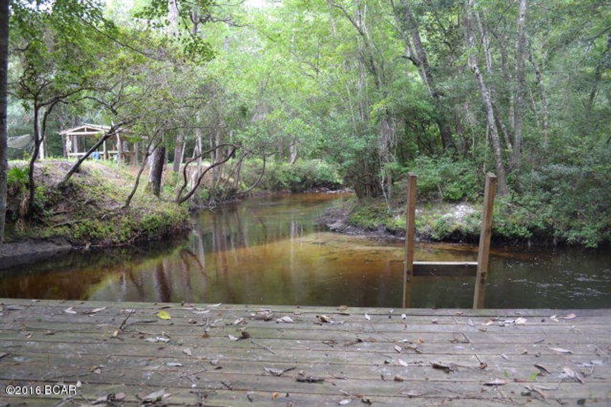 e you looking for the perfect property to build your dream home, or just have a paradise all to yourself? Look no further! This is truly a unique property, the entire southern border(over 1500 ft)sits directly on Four Mile Creek! There is approximately 4.5 acres that are already cleared for a potential home site that is right next to the creek. There is already a large deck/dock that sits right on a bend in the creek that is 10' deep, perfect for swimming or fishing! It also has a very unique feature called Dripping Spring. This area drips water off of a cliff year-round into a small limestone pool that runs right into the creek. It is very relaxing! You and your family could enjoy this area as your own private campsite as well, there is a pole barn with a picnic table already waiting for you! There is also a pond to the right of the cleared space as well. There are trails that have been cut around the property lines and through the middle of the wooded area for hunting, hiking, or ATV riding. Come see this amazing property today!