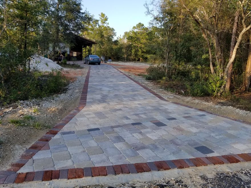 This 3.66 acre lot on a cul-de-sac near a huge clear lake is ready for your new home. Located in the private community of Leisure Lakes, this flat lot already has been improved with some clearing, a 32x48 pole barn on a concrete slab, well, septic tank and field lines, colorful driveway pavers, outdoor shower, 50 amp service for RV hookup, 50 amp service for the shed, and dry storage upstairs of the pole barn. It is just down the street from the pavilion area used for recreation including a swimming pool, basketball court, tennis court, toddler playground, grill stations, outdoor shower, concrete boat launch, men's and women's restrooms, picnic tables, rental kitchen and more! Bring your house plan and get started.