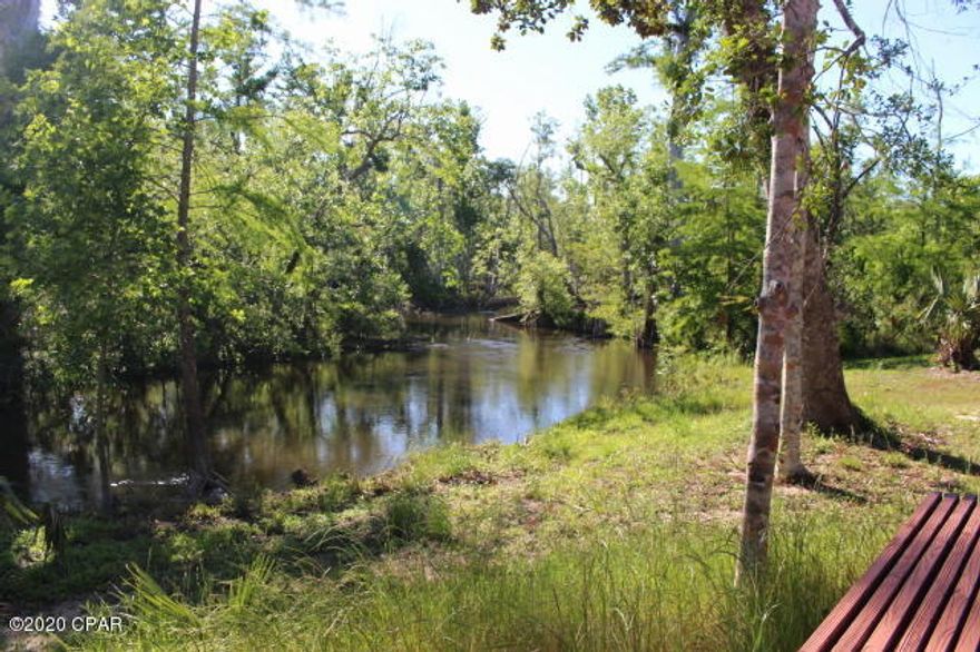 'CURRENTLY UNDER CONTRACT, SELLER ACCEPTING BACKUP OFFERS' Waterfront Wilderness Retreat. Unique compound with 23.20 acres on Florida's spring-fed Chipola River. Take your Virtual Tour on all 3 homes see MLS 696647, MLS 701983 , MLS 701988 (3) 1-bedroom houses, each with its own kitchen and bath plus storage house, office/flex space and freestanding 2 car garage. 5 new roofs! Interiors are a mosiac of rare woods with sweeping views through large plate glass windows. Built and owned by a single family and never on the market before. Make friends with owls and egrets, otters and deer. Put in your canoe or kayak in the front yard or fish from deck. Listen to the wind in the cypress as a chorus of frogs sing you to sleep. This property could be preserved as a family compound or developed as a wilderness sports retreat. Shown by appointment only. This property is occupied