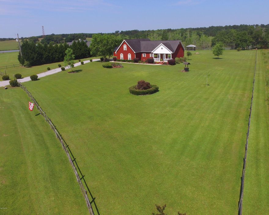 This charming three bedroom, two bath home in Bonifay sits on an expansive lakefront lot! The home enjoys an open concept floor plan allowing the gourmet kitchen, complete with breakfast bar, granite counter tops, stainless steel appliances, and ample cabinet space, to flow seamlessly into the light and bright great room with gorgeous vaulted ceilings and large windows—overall a wonderful space to entertain. Sip your morning coffee in the screened in porch while enjoying the views of the lush, tastefully landscaped gardens and yard. Or walk out to the gorgeous gazebo—complete with ceiling fan and light, to enjoy your morning beverage.  Crown molding, hardwood flooring, recessed lighting and plantation shutters are found throughout the home.  A barn/work area is just outside the house as well as a covered dock. located a convenient distance to the Tri County Airport, this home is not to be missed!