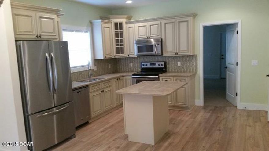 Charming Cottage style Brand New 2 story home in Gated community. Master bedroom on first floor. 3 Bedrooms/2 1/2 baths. Community pool in a 24 unit complex. Located very conveniently to the Navy Base, St. Andrews State Park and the worlds most beautiful beaches! This home is a most see. Master bedroom has its own full bath with full tile shower and glass shower door, and walk-in closet. Home features 9 foot ceilings, upgraded Samsung Stainless appliances with French door refrigerator, carerra marble kitchen countertops. Solid white shaker wood cabinets with glass door and crown molding. Each unit has a gated area for a large private storage space.