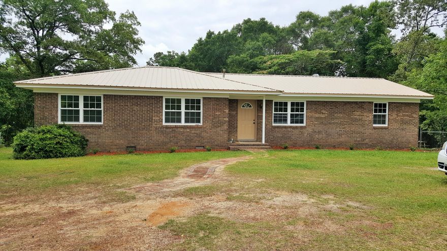 Absolutely lovely 3/2 brick home that has been totally renovated.  New doors inside and out, new flooring, new windows, new paint, new custom cabinets in kitchen and both bathrooms, new metal roof, new water heater, new ac/heat unit and much more. It also boasts a huge bonus room. This home is located close to town and is one 5 acres. Approximately 4 acres behind the home is chainlink fenced in.  Make your appointment today.