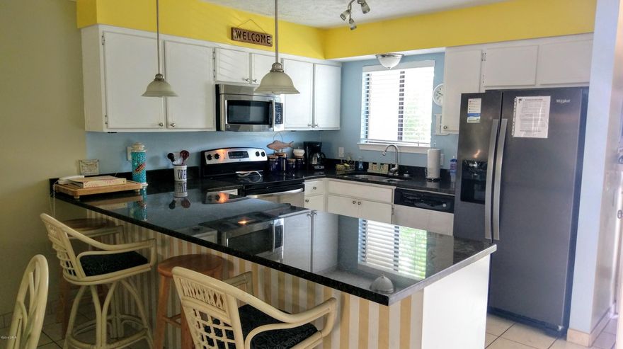 Currently under contract, seller accepting back up offers.Age, SF, and dimensions approximate. A very nice ''Glassback'' unit This 2 bedroom, 2 1/2 bath unit has an updated kitchen and bathroom vanities. Completely tiled downstairs. New roof to be put on soon. Complex has 11 pools to include clubhouse with pool on the beach. Gated community and pet friendly.