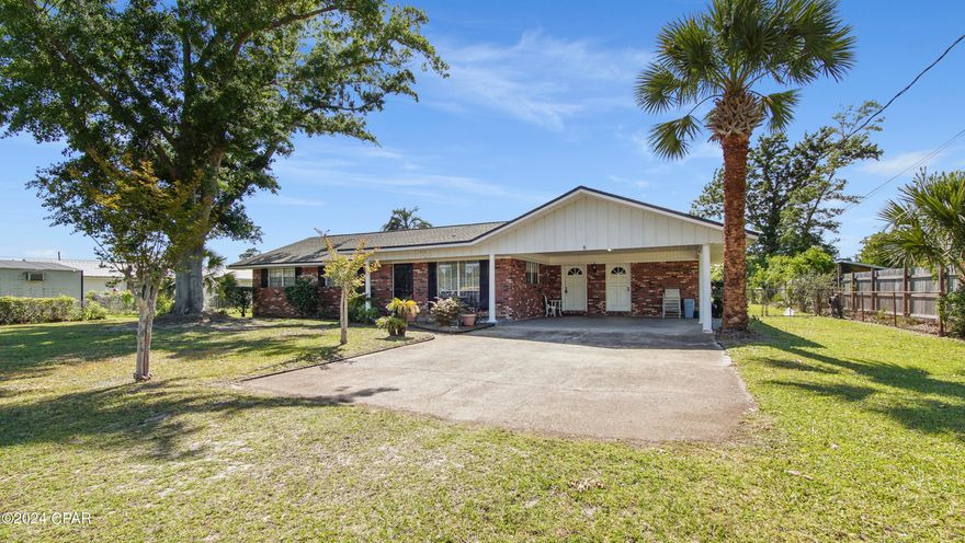 Lovely landscaped brick home with many extras including a large .69 acre lot. One of the main features of the home is the family room with a wood burning fireplace, natural light, breakfast bar and reach through to the kitchen. The kitchen has plenty of cabinet and counterspace for preparing those good home cooked meals. Master bedroom has newer vinyl plank flooring, walk in closet and separate bathroom. As you walk in the front door you are greeted by the large living room great for entertaining and relaxing. All bedrooms are a comfortable size with closets and individual ceiling fans. The utility room has its own entrance from the back yard and has a bathroom with shower to clean up after working in the yard. Two car carport has an entrance into the mudroom/foyer and a separate door for the bonus room. Large back yard has plenty of space for a swimming pool, playground and garden. Enjoy cool evenings sitting in the covered front porch. Home is located close to Tyndall AFB, parks, schools, boat launches, and stores. All measurements are approximate, please verify if important. Contact your favorite Realtor today for a private showing.