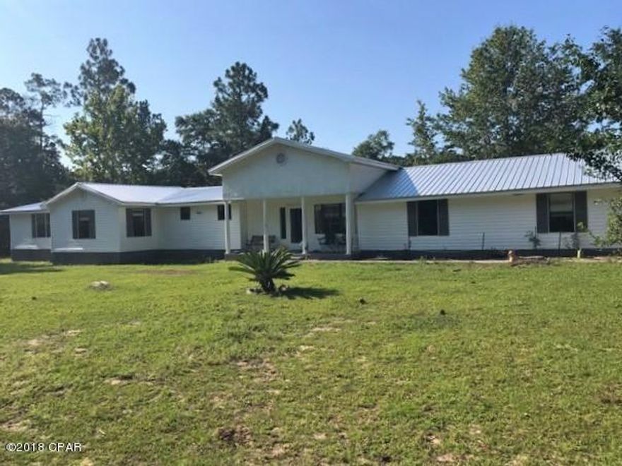 GORGEOUS LAND!! Private entrance, fenced for horses or other animals. Mobile home has sight built extensions. Home has been partially redone however needs some TLC in the unfinished part. Has new metal roof, central heat and air, two car detached garage with lean-to and is cross fenced. Private country setting off a paved road. Bring offers!!!