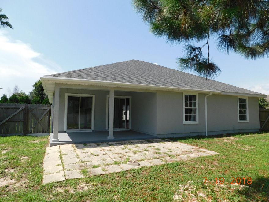 Much sought after community with community pool, located within walking distance to Pier Park. This is a 4 bedroom 2 bath newly remodeled home to include a new roof, exterior and interior paint, laminate plank flooring throughout except for 3 bedrooms have new carpet. New vanities in the bathrooms.Master bedroom has walk in closet and private bath with walk in shower.Eat in kitchen with pass thru window into the Living room area and formal dining area also new Stainless appliance package as well as granite counter tops. Living room has fireplace and sliding doors from both living room and kitchen area leading out to the covered porch and large fenced back yard. Leading out to the garage you also have a nice size laundry room. Call