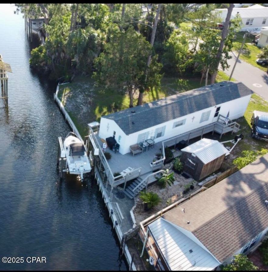 Welcome to your waterfront getaway!  With no HOA fees.  This beautiful Panama City Beach home sits right on the canal - perfect for boating and soaking up coastal living at its best!

Bring your boat and enjoy direct access to the water from your own backyard.

This incredible 2-bedroom, 2-bathroom pearl with almost 1000 sq. ft.  well-maintained living space with a large wrapped around deck, room for lounge chairs or just having dinner by the water.  Featuring a spacious layout, the home has been meticulously cared for and is move-in ready.

Key highlights include:
Modern amenities: Recently updated roof and HVAC systems for peace of mind.

Outdoor living: Enjoy the near-new boat lift, perfect for water enthusiasts, and ample outdoor space. Just lower your boat into the water and be in the Gulf in  minutes. Fish, play with the Dolphins or just enjoy amazingly beautiful sunsets, are just some of the intrinsic values of this property.

Parking: Generous parking with at least 4 spaces available, ideal for hosting guests or storing vehicles.

Location: Situated in a prime, highly desirable location that offers both convenience and tranquility.

This home offers both comfort and functionality don't miss the opportunity to make it yours! This is the Emerald Coast lifestyle you've been waiting for. A true investment with unlimited possibilities.