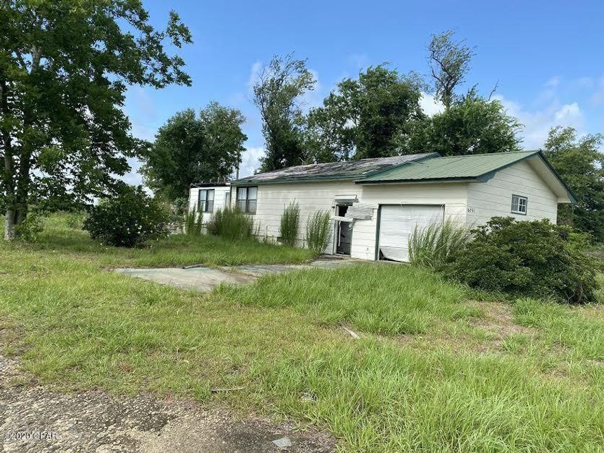 One acre on Hwy 90. The house is a total loss from Hurricane Michael. It has well and septic but unknown if operable.  Great location for a new home or a business.