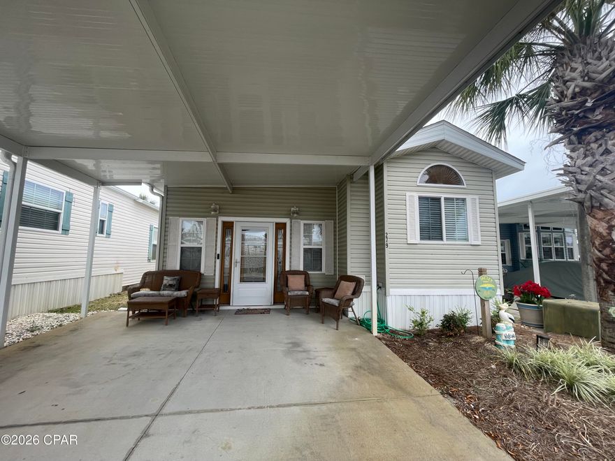 This cute 2 bedroom 2 bath cottage in Emerald Pointe Resort is move in ready, and will be fully furnished with very nice furnishings and décor. It has a large master bedroom, a nice sized living room, an office area, a large sized screened in patio, new LVP flooring throughout, and a 2-car carport. The property also has a storage and laundry room with stackable washer / dryer located in the screened in. Additional updates include: new furniture and decorations 2022, flooring 2022, AC 2019, and hot water heater 2018. Emerald Pointe Resort is a gated community located in the heart of Panama City Beach close to restaurants, shopping, and only 2 miles the world's most beautiful beaches. Amenities include a large clubhouse, exercise room, shared library, 2 pools (one heated seasonally), hot tub, lake with boardwalk, and shuffleboard court. HOA fee includes water, sewer, garbage, new  fiber optic internet, and lawn service. All information is approximate and should be verified by buyer if important.